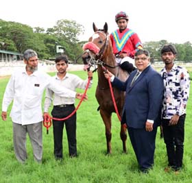 Power Of Gold (Akshay Kumar up) winner of the SOMANATHPUR PLATE (DIV-II), being led in by trainer Darius R Byramji on Friday races at Mysore.